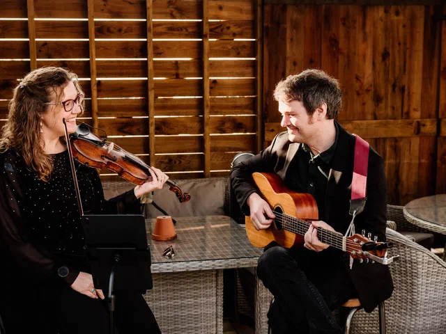 Sarah and Tom playing violin and guitar together