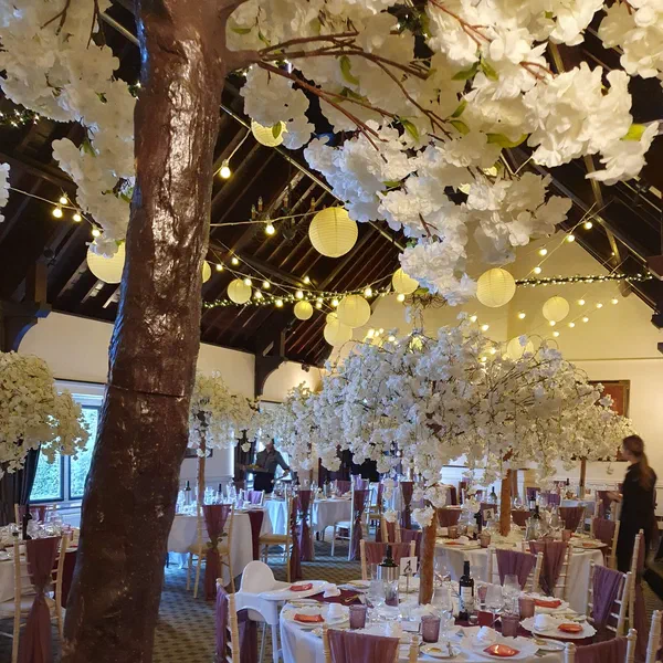 Barn venue decorated with white cherry blossom trees